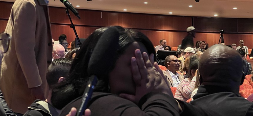 Nakisha "Nikki" Evans, a recently elected Brooklyn district leader, seeks respite behind her hands as the Brooklyn Democratic Party’s biannual organizational meeting goes off the rails.