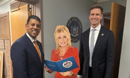 State Sens. Jeremy Cooney and Erik Bottcher pose with a lifesize cut-out of President Parton.