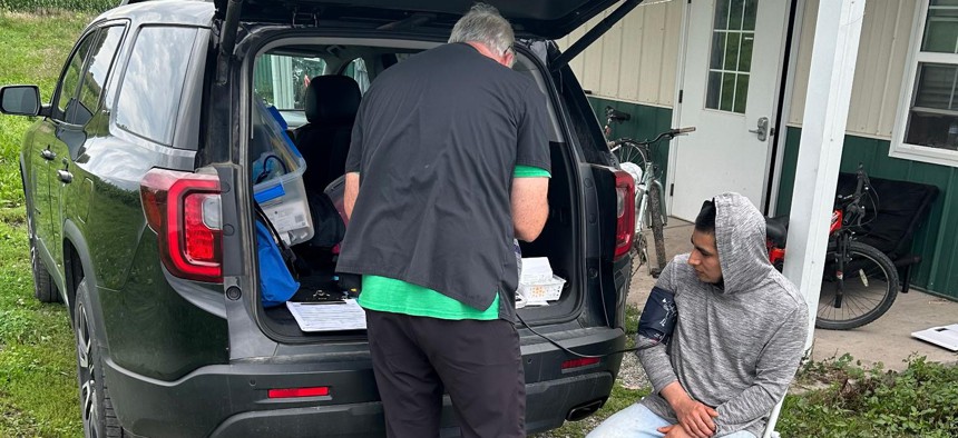 An Oak Orchard Health staffer takes a farmworker’s blood pressure.