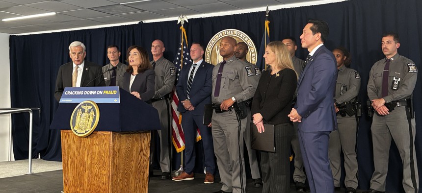 Gov. Kathy Hochul touted insurance fraud arrests flanked by law enforcement and other government officials.