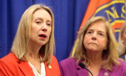New York State Inspector General Lucy Lang (left) announces prosecutions from an investigation into a cheating scheme at the state's Department of Motor Vehicles in Mineola, N.Y., on Oct. 9, 2025.