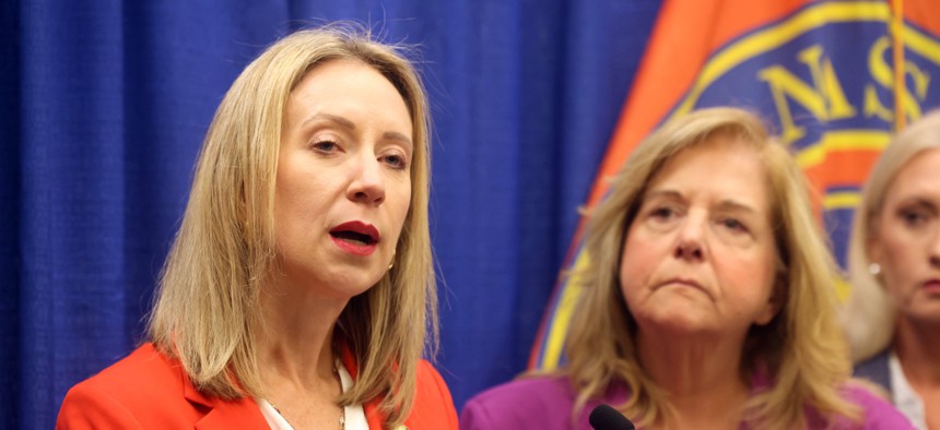 New York State Inspector General Lucy Lang (left) announces prosecutions from an investigation into a cheating scheme at the state's Department of Motor Vehicles in Mineola, N.Y., on Oct. 9, 2025.